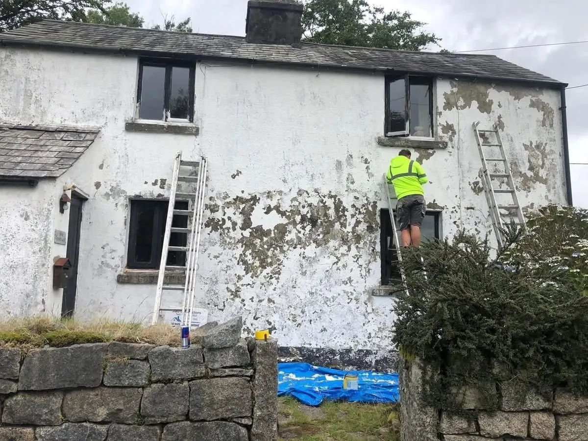 Cottage with blown, flaking render before repair in Looe